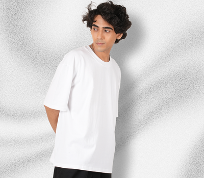 Person wearing a white t-shirt against a textured gray background